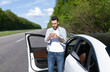 © Prostock-studio - Upset young man standing near car, looking at smartphone screen, having problem with mobile connection, trying to find network on highway. Road emergencies, calling breakdown service, no signal