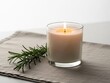 © Hapija - Candle with rosemary branch isolated on white background