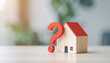 © hardvicore - Miniature wooden house with red question mark, real estate property concept, soft background