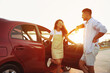 © New Africa - Happy couple near car outdoors at sunset. Summer trip