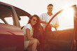 © New Africa - Happy couple near car outdoors at sunset. Summer trip