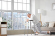 © Pixel-Shot - Senior man with walker trying to stand up after fall at home