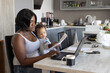 © Anna Berkut/Stocksy - mother working from home with child on her lap