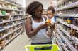 © Anna Berkut/Stocksy - woman with child in supermarket, buy food in grocery store