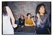 © Yana Bulgakova/Stocksy - Friends enjoying karaoke at a lively bar on a weekend night
