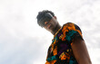 © Marco Govel/Stocksy - Man wearing traditional African shirt against sky portrait