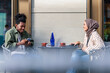 © Jovo Jovanovic/Stocksy - Young couple enjoying coffee and conversation at an outdoor cafe.