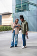 © Jovo Jovanovic/Stocksy - Two young professionals review a tablet outside a modern building.