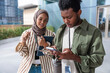 © Jovo Jovanovic/Stocksy - Two young professionals collaborate using a phone and tablet.