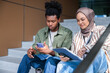 © Jovo Jovanovic/Stocksy - Two young adults look at phone and tablet.