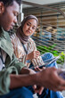 © Jovo Jovanovic/Stocksy - Colleagues collaborate on a tablet device outdoors.