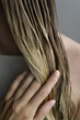 © Asya Molochkova/Stocksy - Close-Up of Hand Touching Wet Blonde Hair