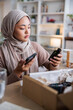 © Jovo Jovanovic/Stocksy - Woman comparing online description with real product