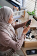 © Jovo Jovanovic/Stocksy - Customer looking at new beauty purchases