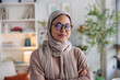 © Jovo Jovanovic/Stocksy - Portrait of a Muslim woman wearing a hijab and glasses