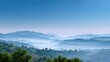 © Matcha_09 - Serene Misty Mountainscape with Layered Hills Under a Clear Blue Sky Illuminated by Soft Morning Light