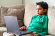 © Christine La/Stocksy - boy browsing laptop