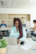 © Santi Nuñez/Stocksy - Focused black businesswoman working on laptop in modern office