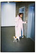 © Asya Molochkova/Stocksy - Film photo of woman with dog waiting for elevator