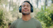 © peopleimages.com - Headphones, peace and health with man in nature for streaming service, meditation sound and calm. Workout playlist, wellness podcast and music with person outdoor for zen audio, radio and relax