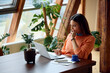© Boris Jovanovic/Stocksy - Pleased woman focused on remote work