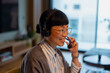 © Artcore Studio/Stocksy - Asian woman working from home using headset