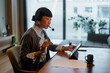 © Artcore Studio/Stocksy - Asian woman working remotely on video call using tablet