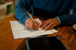 © Artcore Studio/Stocksy - Person signing important document, preparing contract and paperwork