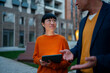 © Artcore Studio/Stocksy - Business colleagues discussing project with skepticism and tablet