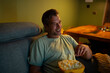 © Artcore Studio/Stocksy - Mature man relaxing at home watching movie