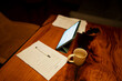 © Artcore Studio/Stocksy - Desktop workspace with contract, tablet, pen, and coffee