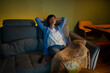 © Artcore Studio/Stocksy - Woman relaxing at home watching movie with popcorn
