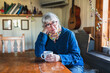 © Diego Martin/Stocksy - Relaxed Senior Woman with Coffee in Cozy Cottage Interior