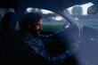 © Artcore Studio/Stocksy - Man driving in a car at dusk while enjoying a thoughtful moment