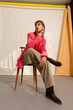 © valbar STUDIO/Stocksy - Stylish Model Poses in Pink Blazer and Brown Boots