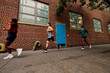 © Boris Jovanovic/Stocksy - Running group in town