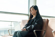 © Yic Ma/Stocksy - Chinese woman using laptop at airport