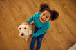 © Boris Jovanovic/Stocksy - Little girl hugs her dog with joy