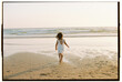© Olga Moreira/Stocksy - Child walking alone toward the ocean at sunset