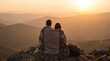 © robbi - Romantic couple wrapped in blanket watching epic sunset over vast mountain landscape from a mountaintop