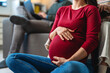 © NDABCREATIVITY - Closeup beautiful pregnant woman belly with her hands. Happy mother waiting for baby birth.