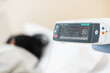 © arcyto - Close up adjust infusion pump set iv fluid intravenous drop saline drip with blurry patient woman on hospital bed in hospital room.Medical treatment emergency patient concept