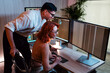 © artitwpd - Two people focus on coding and analyzing data across multiple computer monitors in a bright office, collaborating on technology, programming, and strategic planning in a modern professional setting.