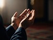 © Mohamed - Person praying with hands together in dark room