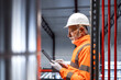 © littlewolf1989 - Senior engineer using tablet in industrial facility