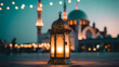 © OhiStock - Islamic lantern glowing in front of mosque at sunset