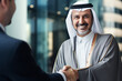 © ink drop - portrait of a middle aged arabian businessman with hand reaching out to shake hands. Business deal