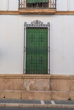 Green window with decorative ironwork on white wall.. Ronda, Málaga, Spain