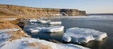 Sun-kissed Cliffs and Drifting Ice Floes on a Serene Arctic Coast