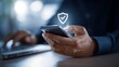 © topperstock - Businessman Using Smartphone with Glowing Shield Check Mark Icon for Mobile Security and Verified Data Protection Concept